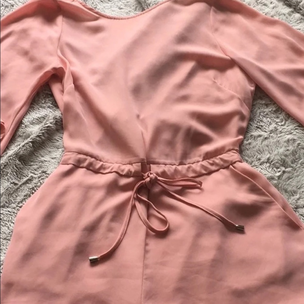 Blush Romper 
Tie back 
Bell sleeve